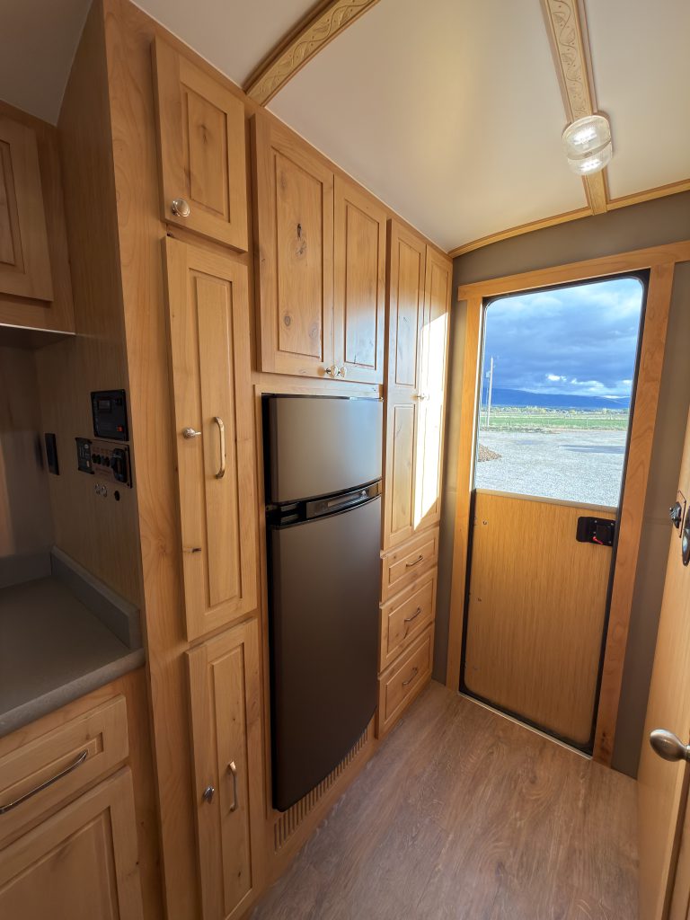 Van Niewkoop Camp #136: Entry storage with a tall closet, three lower drawers, and the Dutch door beside it.
