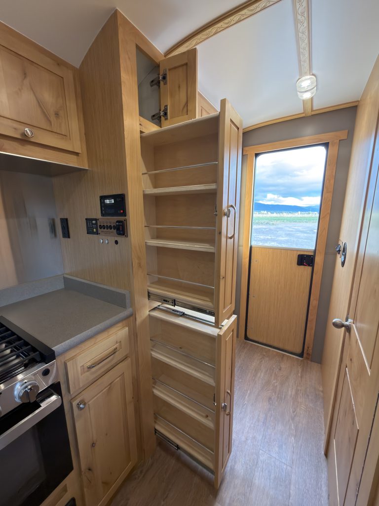 Van Niewkoop Camp #136: Upper and lower pull-out pantries extended beside the kitchen counter.