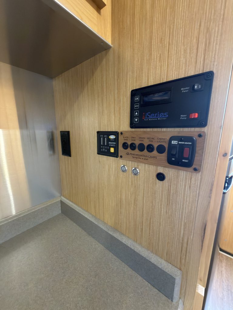 Interior controls mounted above the kitchen counter in Van Niewkoop Camp #136.