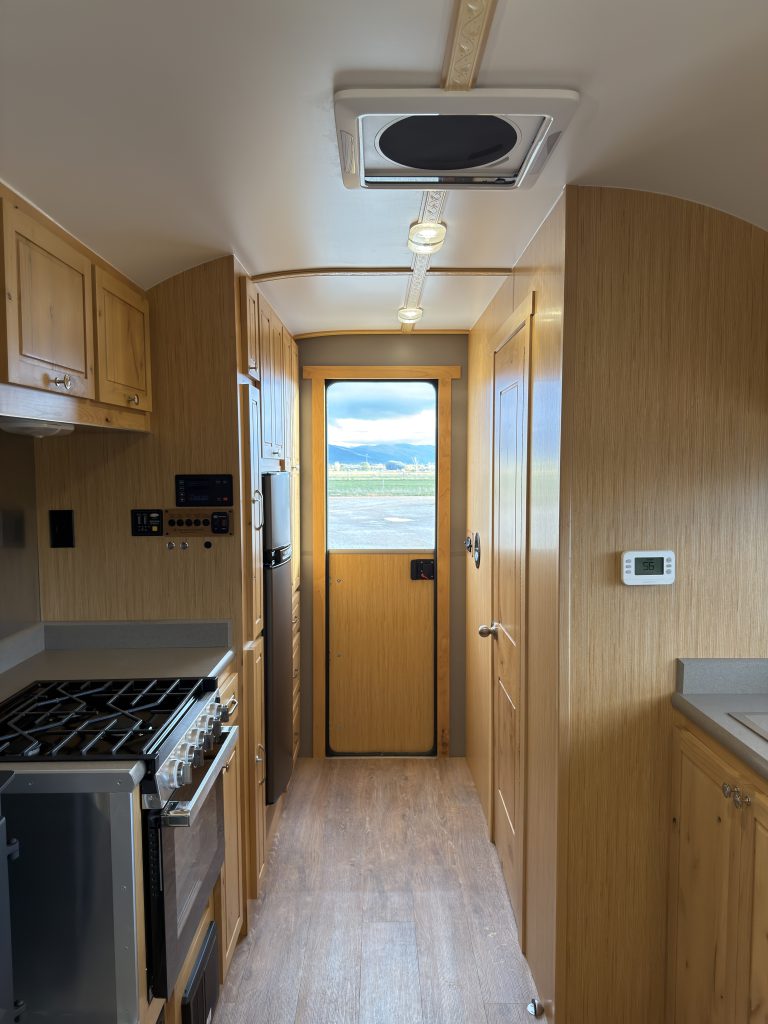 View down the kitchen aisle toward the entry door in Van Niewkoop Camp #136.