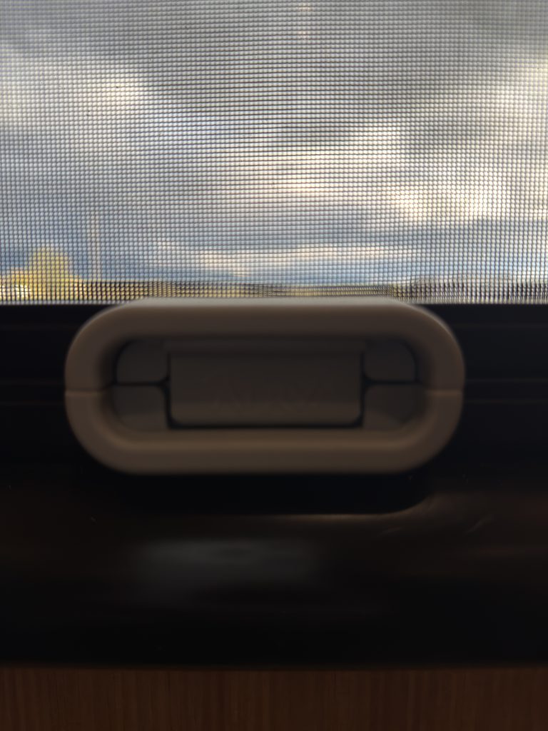 Close view of the window latch against the glass in Van Niewkoop Camp #136.