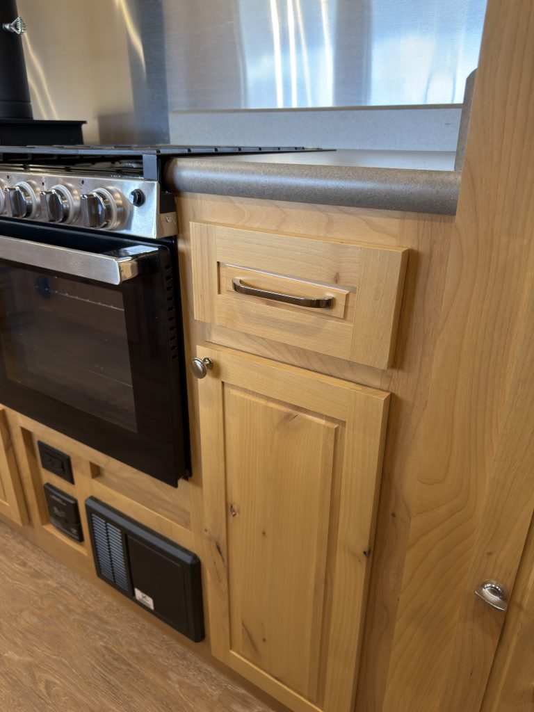 Van Niewkoop Camp #136: hardwood drawers and base cabinet beside the GE kitchen range.