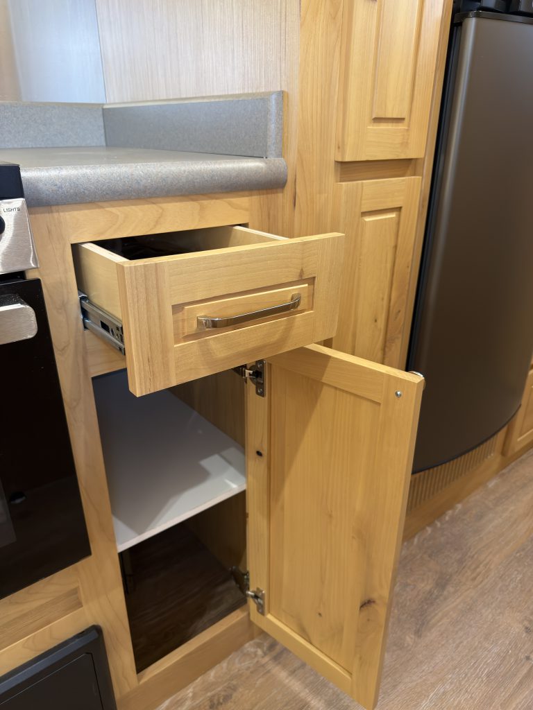 Van Niewkoop Camp #136: Kitchen drawer and lower cabinet opened beside the GE range.