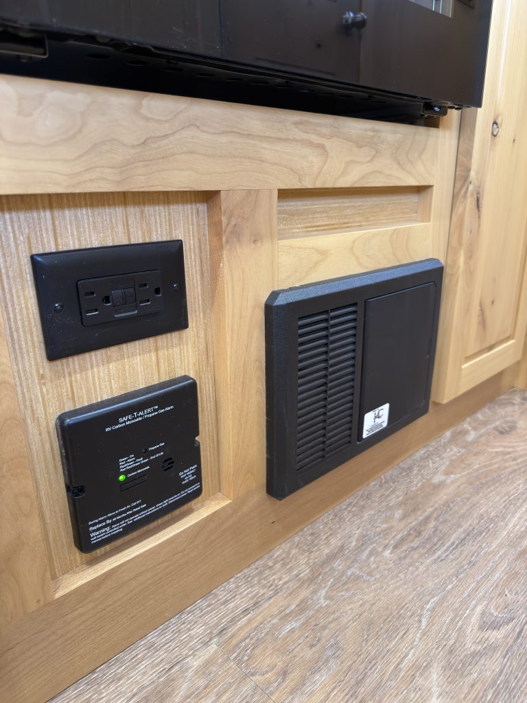 Van Niewkoop Camp #136: AC/DC electrical power center and adjacent lower panels beneath the kitchen appliances.