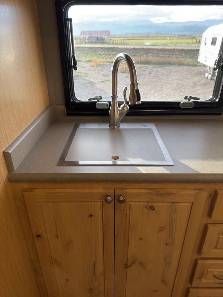 Van Niewkoop Camp #136: Kitchen sink and faucet above the hardwood base cabinet.