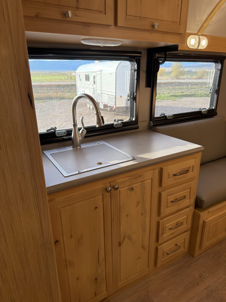 Van Niewkoop Camp #136: Single kitchen sink, wood base cabinet, and adjacent built-in drawer stack.
