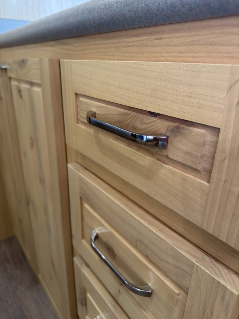 Van Niewkoop Camp #136: Close view of a brushed nickel bar-style pull on a hardwood drawer front.