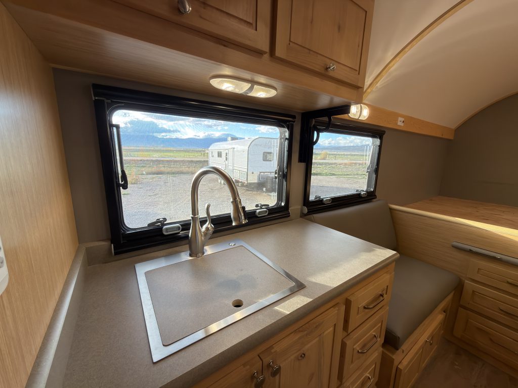 Van Niewkoop Camp #136: Kitchen sink and faucet beneath Arctic Tern Classic windows.
