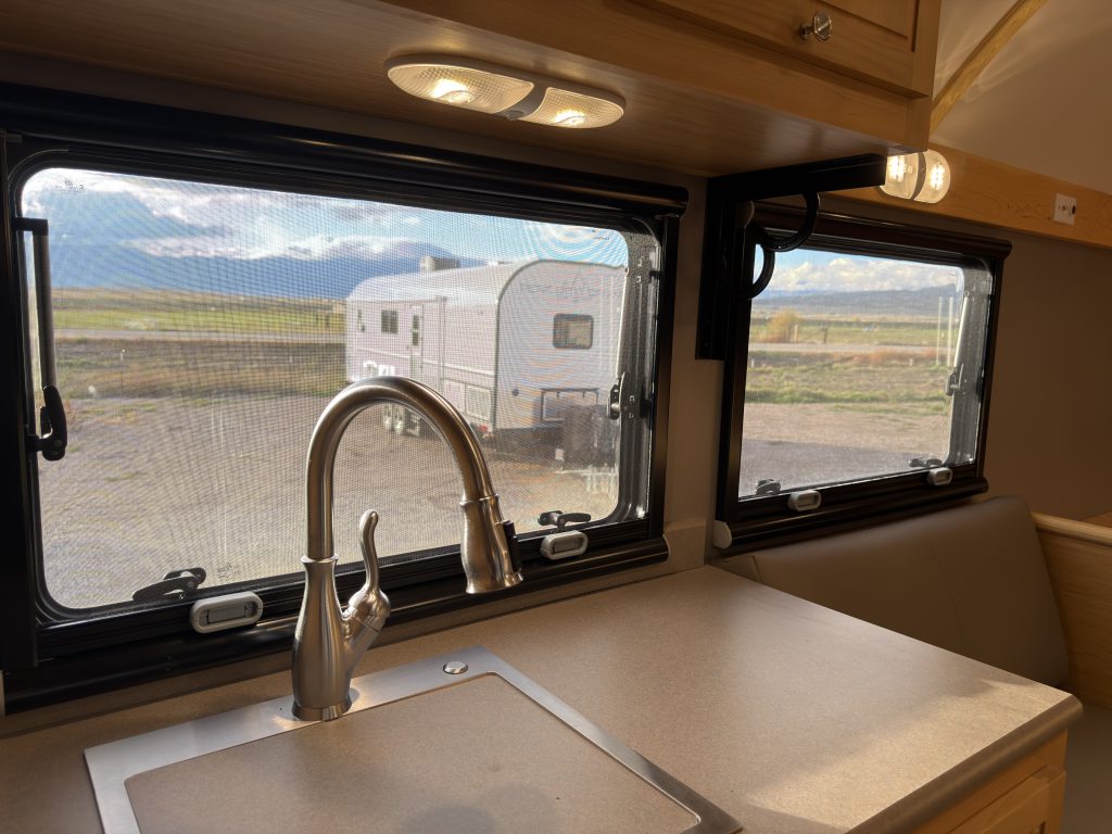 Van Niewkoop Camp #136: Kitchen faucet in front of the black-framed Arctic Tern Classic windows.