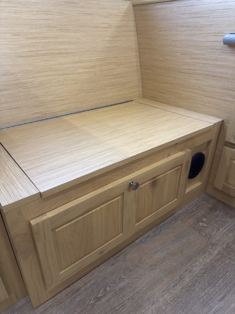 Van Niewkoop Camp #136: Closed wood lid over the soup-box storage compartment in the bench.