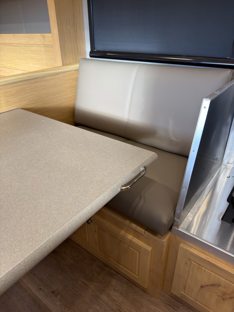Van Niewkoop Camp #136: Upholstered dinette bench beside the extended pull-out table.