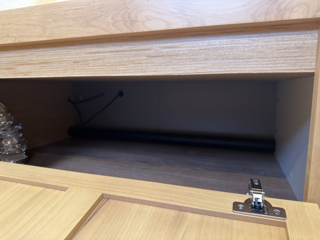 Van Niewkoop Camp #136: Close view inside the cabinet storage beneath the bench seat.