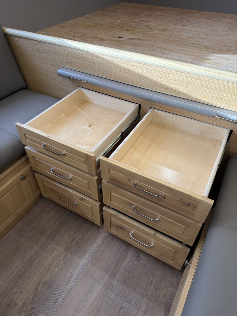 Van Niewkoop Camp #136: Deep wood storage drawers extended below the rear bed platform.