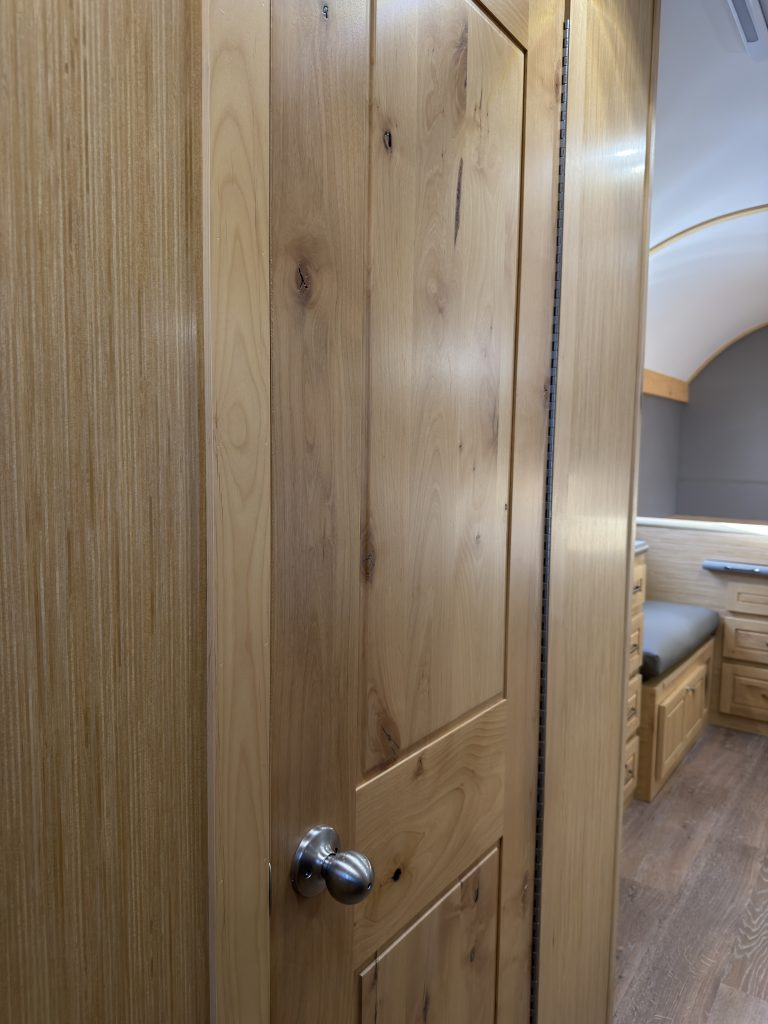Van Niewkoop Camp #136: Close view of the solid hardwood bathroom door and round handle.