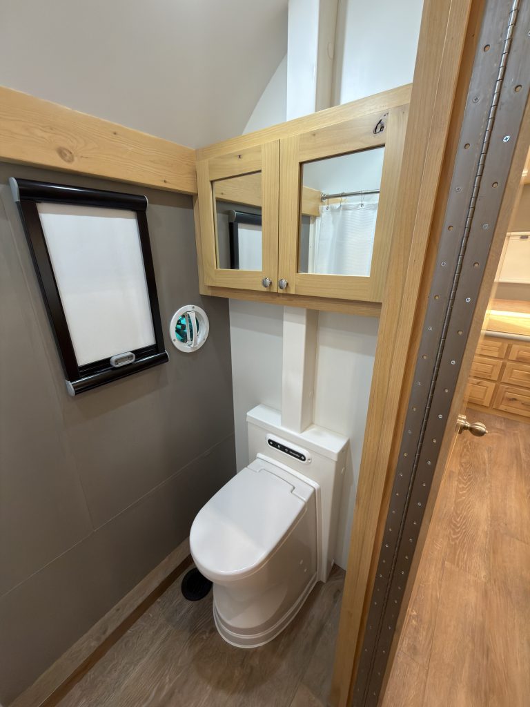Van Niewkoop Camp #136: Bathroom with a Cinderella incinerating toilet, mirrored medicine cabinet, and window.