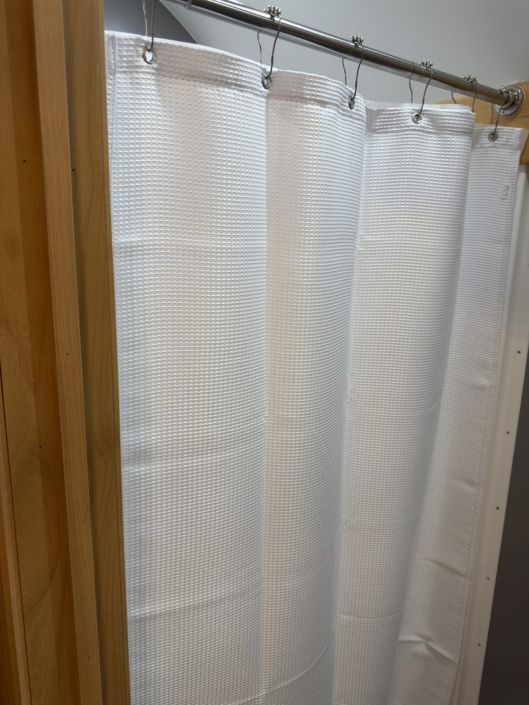 Van Niewkoop Camp #136: Curtain across the 32-by-32-inch bathroom shower opening.
