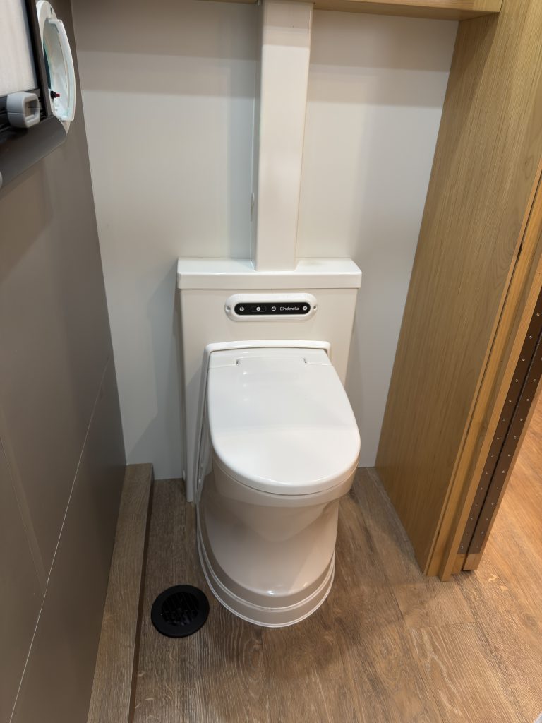 Van Niewkoop Camp #136: Cinderella incinerating travel toilet beneath the medicine cabinet.
