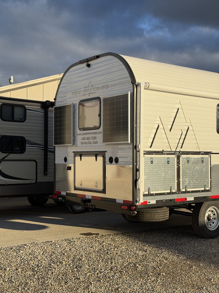 Rear three-quarter view showing the side storage doors in Van Niewkoop Camp #136.