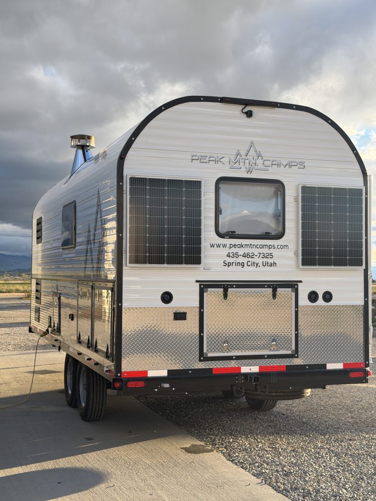 Van Niewkoop Camp #136: Rear egress window between two solar panels above the storage hatch.