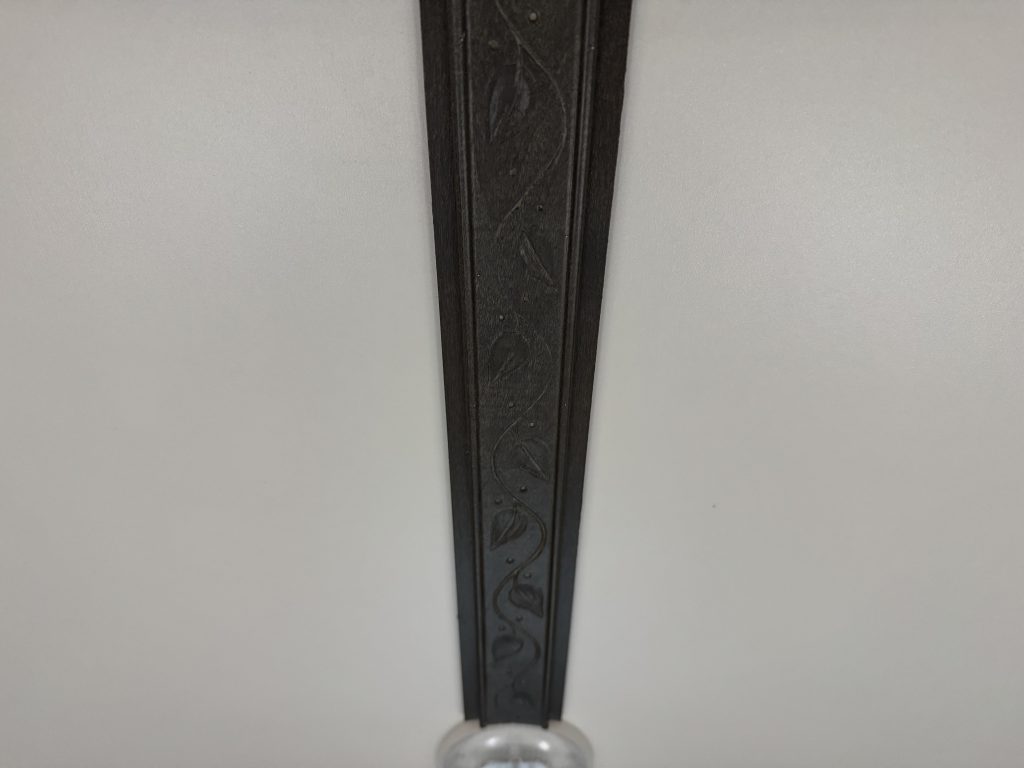 Close view of rosewood trim against the curved white ceiling in Watson Camp #134.